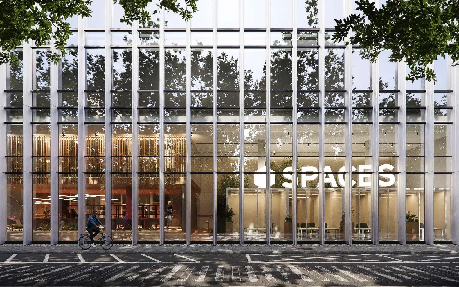 Spaces Zuidas seen from the street, with the coffee bar and communal areas visible through the glazed facade
