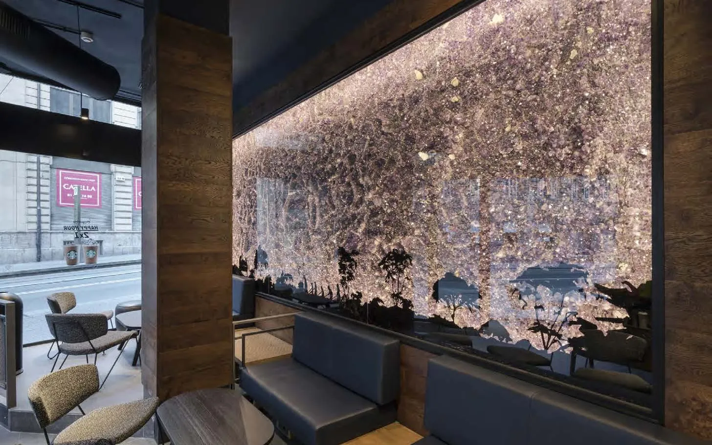 Amethyst stone wall lit from behind beside window seating