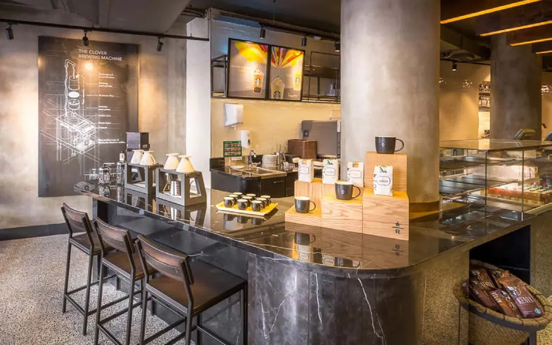 Black marble bar with brewing equipment and stools